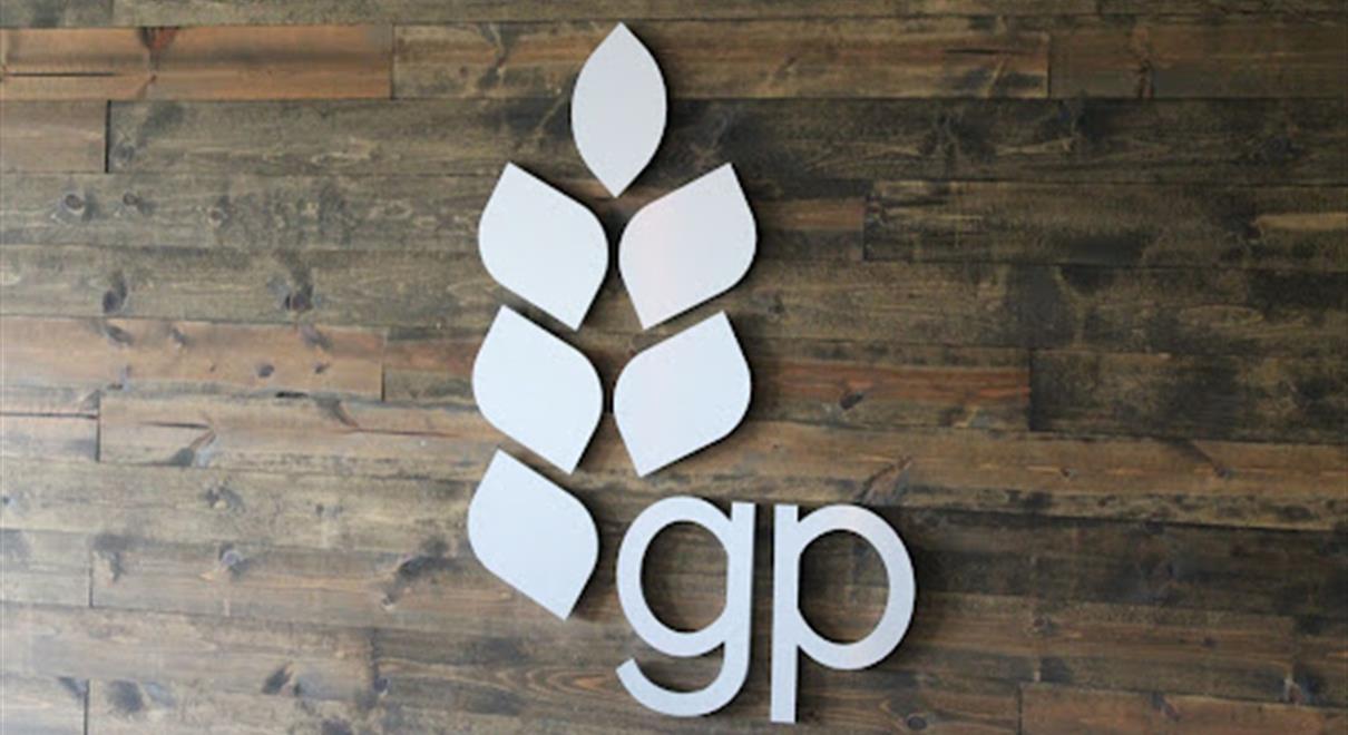 A company uses a wall sign to show their logo