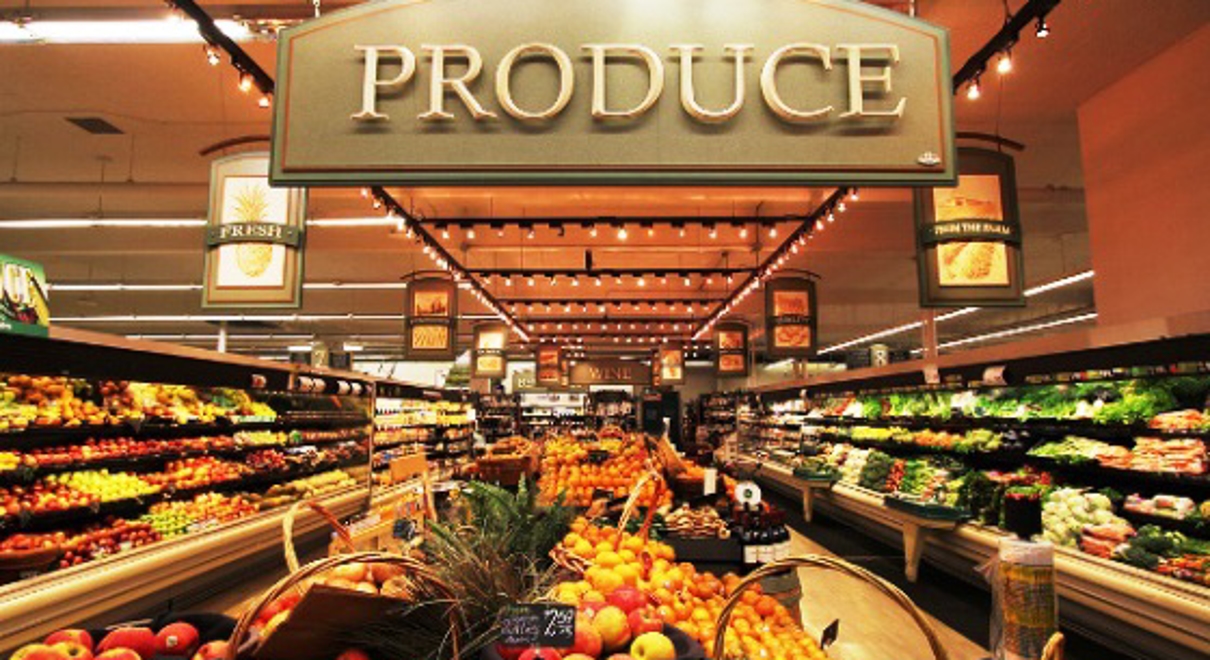 a large sign indicates the produce section of a grocery store