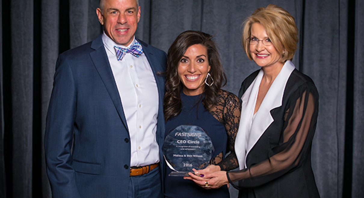 Ben and Melissa Wilson receive the CEO Circle award from Catherine Monson