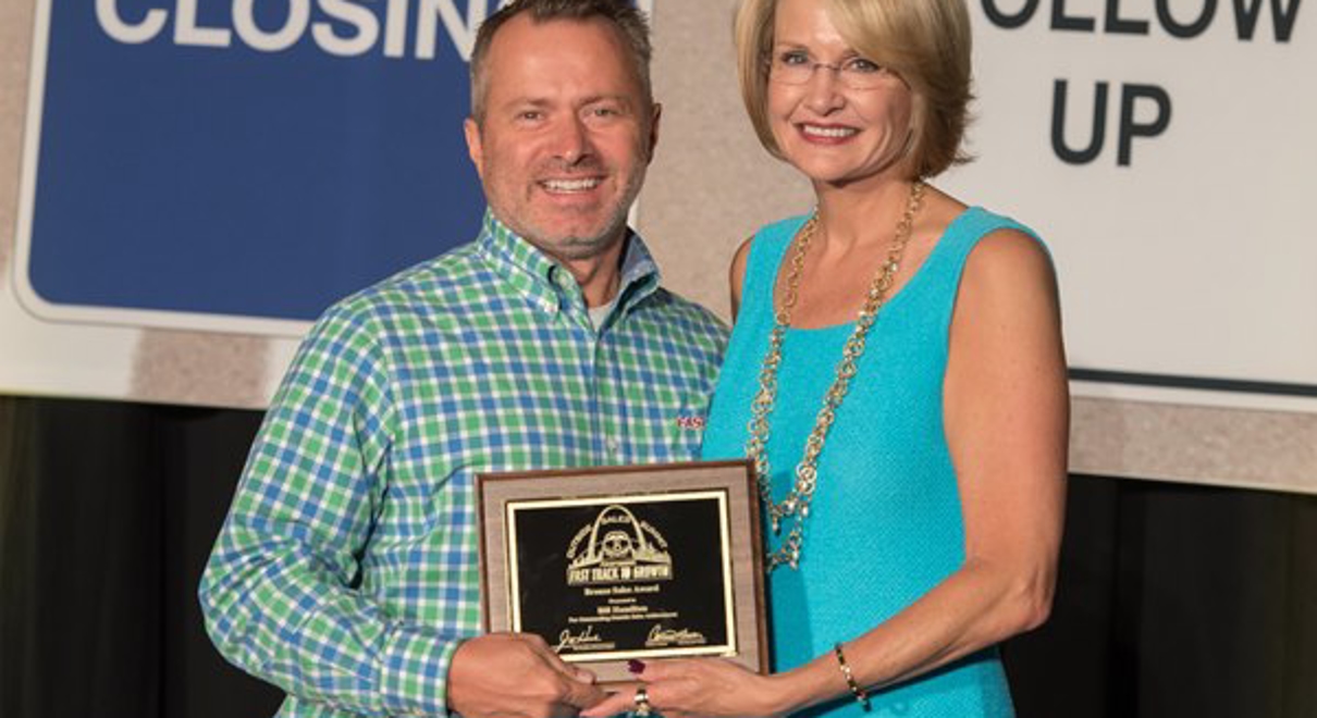 Bill Hamilton is awarded the bronze sales award by catherine monson