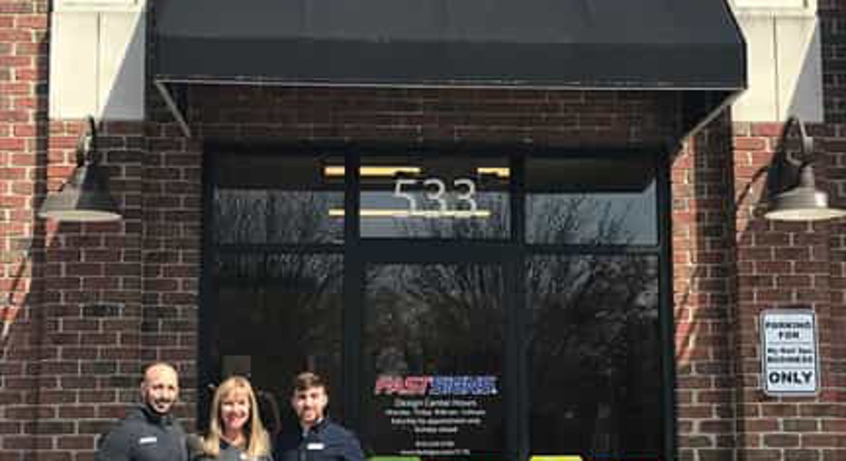 the FASTSIGNS of Brighton team outside the store