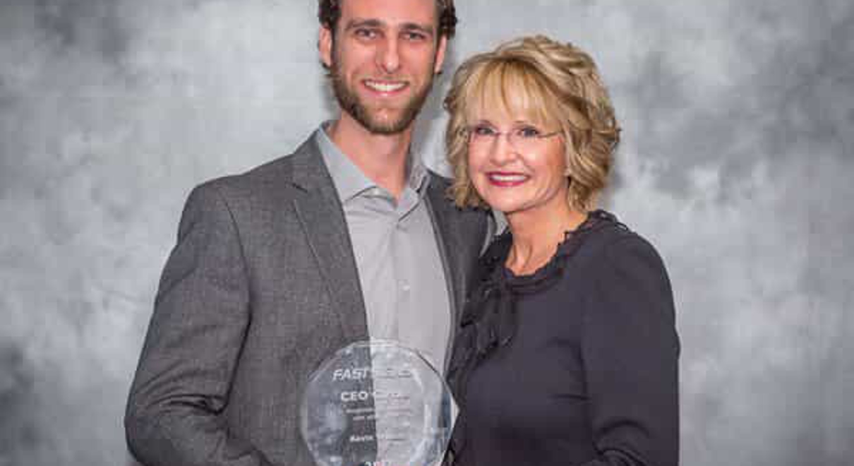 owner Kevin Wenck receives the CEO Circle Award presented by Catherine Monson, CEO of FASTSIGNS International, Inc., at the 2018 FASTSIGNS Convention.