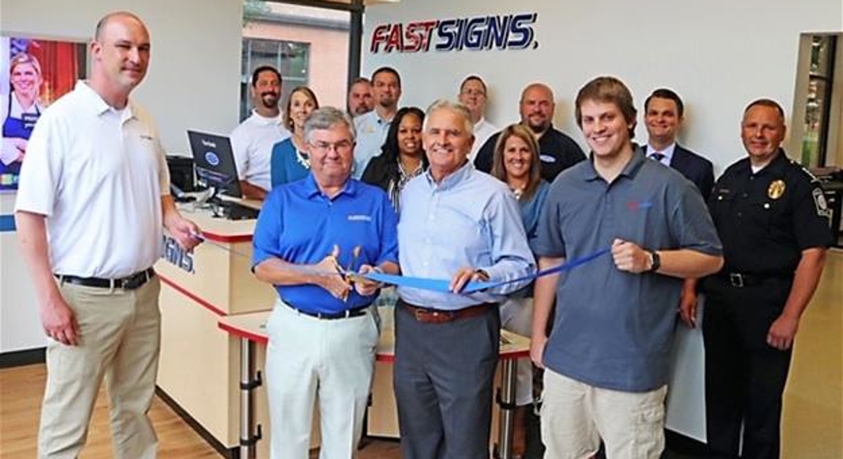 Ribbon cutting with franchise staff