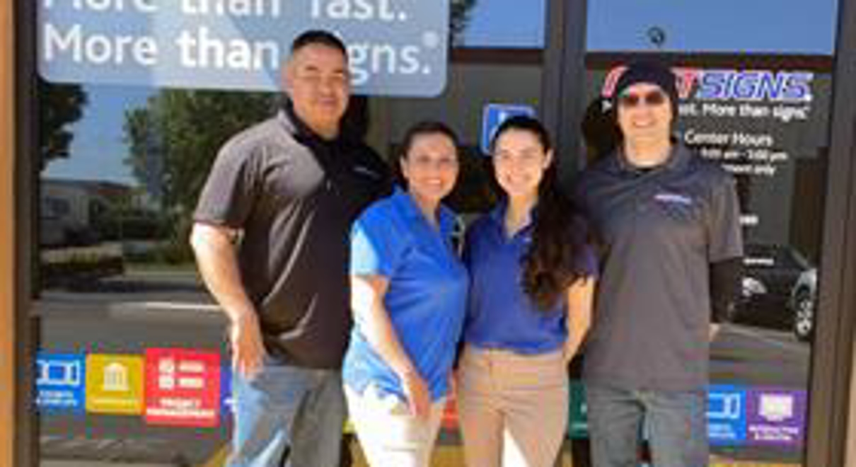 Owners in front of store