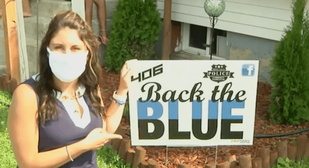 Lady holding a Back the Blue signage