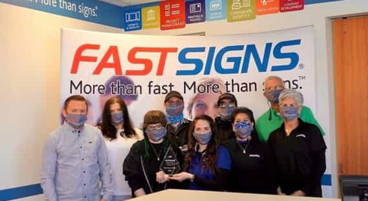 The FASTSIGNS Arvada team with the Pinnacle award