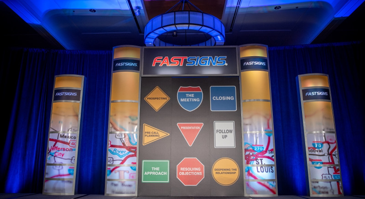 a wall of graphics at a fastsigns conference