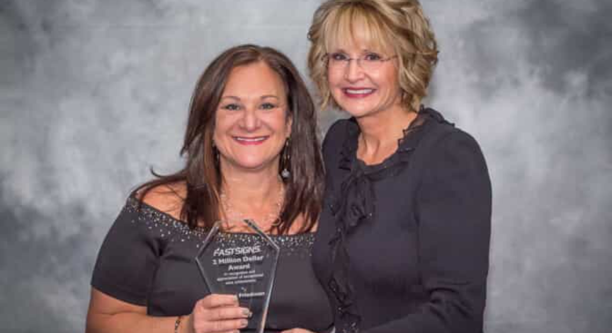 Renee Friedman receives the $2 million award from Catherine Monson