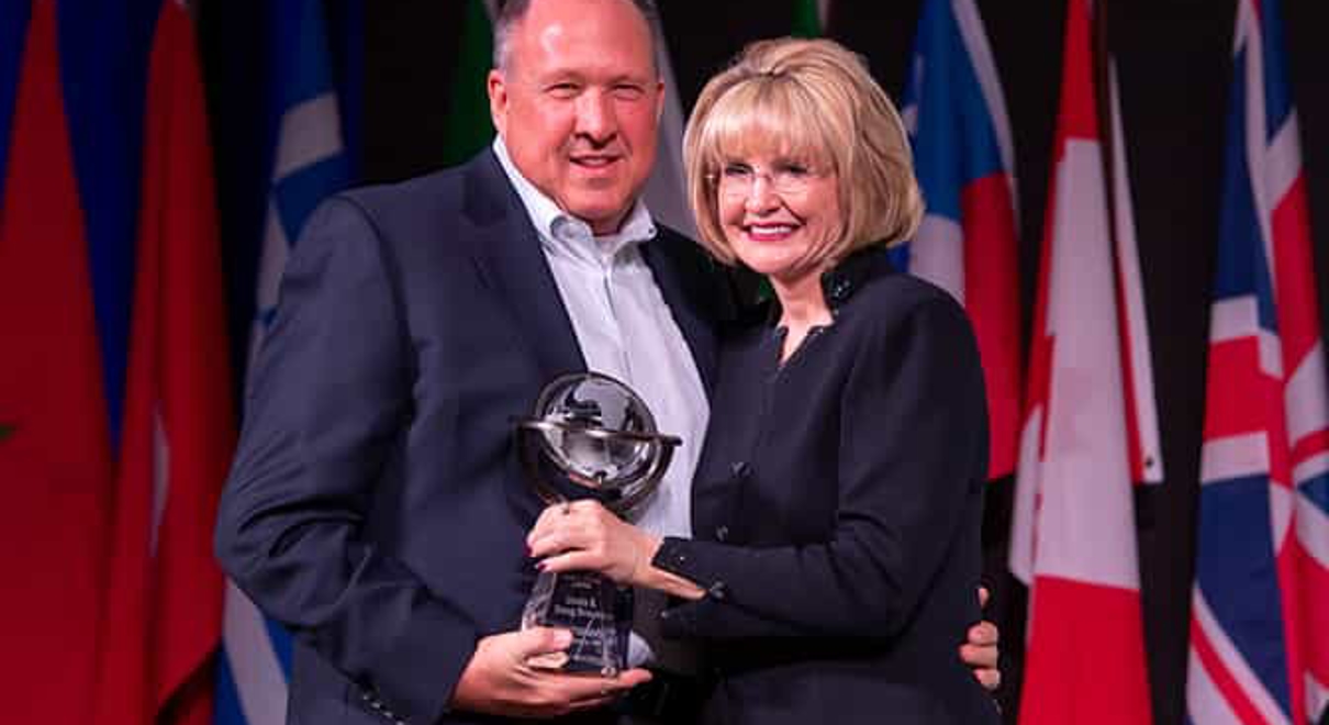 Doug Brauer and Catherine Monson with a Sales Achievement Award