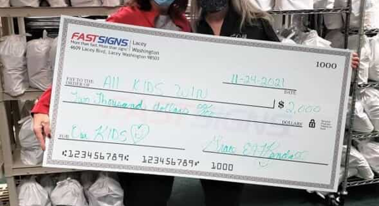 FASTSIGNS of Olympia, WA-Lacey presents a check to All Kids Win