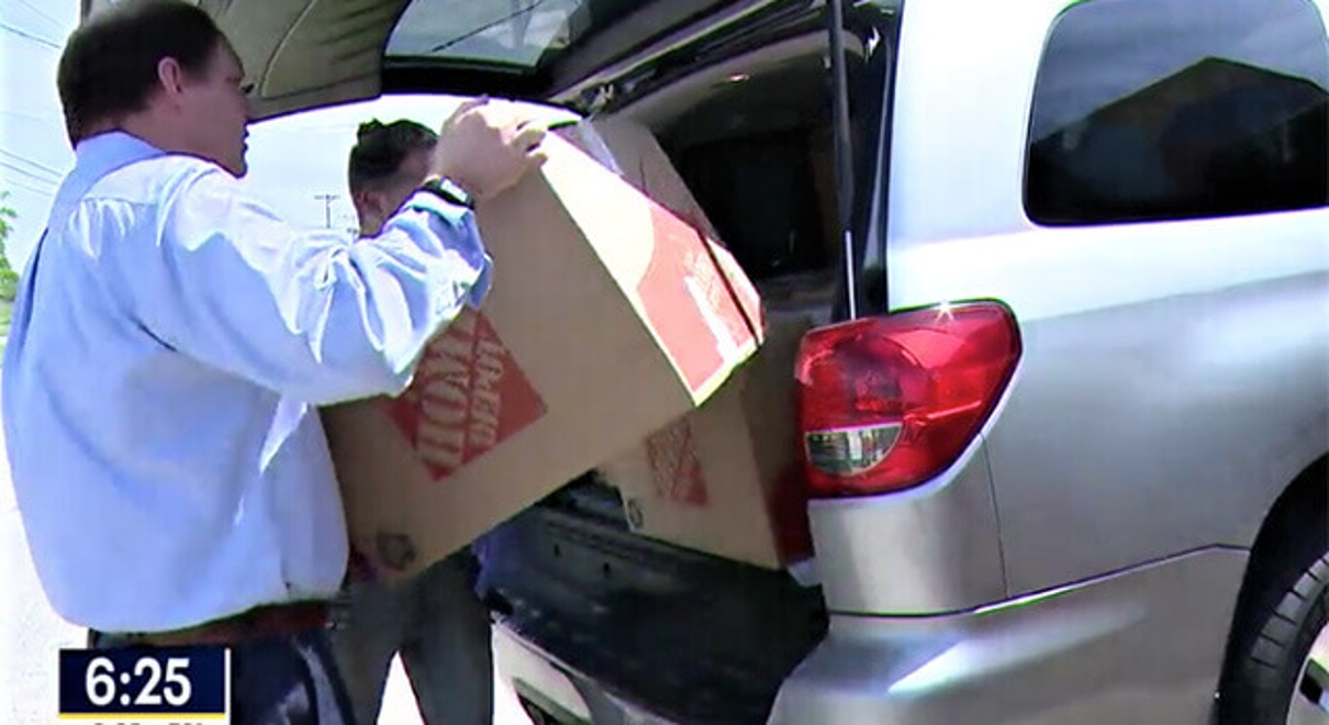 Men loading boxes in the car