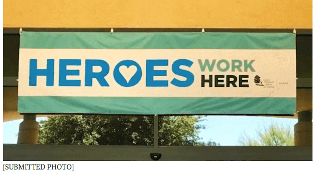 “Heroes Work Here”  banner