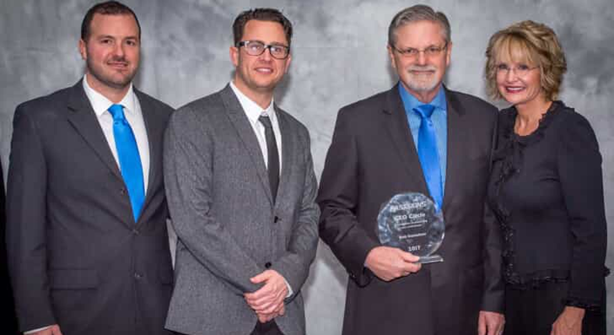 The team at FASTSIGNS of omaha receive the CEO Circle award from Catherine Monson