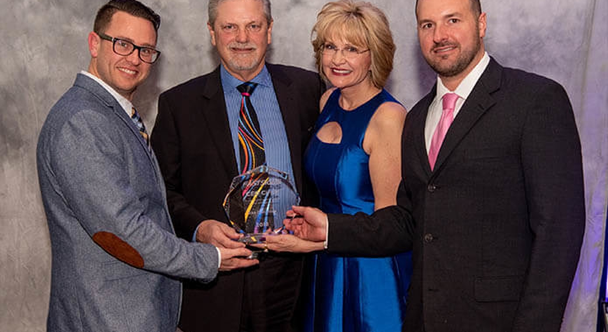 The team at FASTSIGNS of omaha receive the CEO Circle award from Catherine Monson