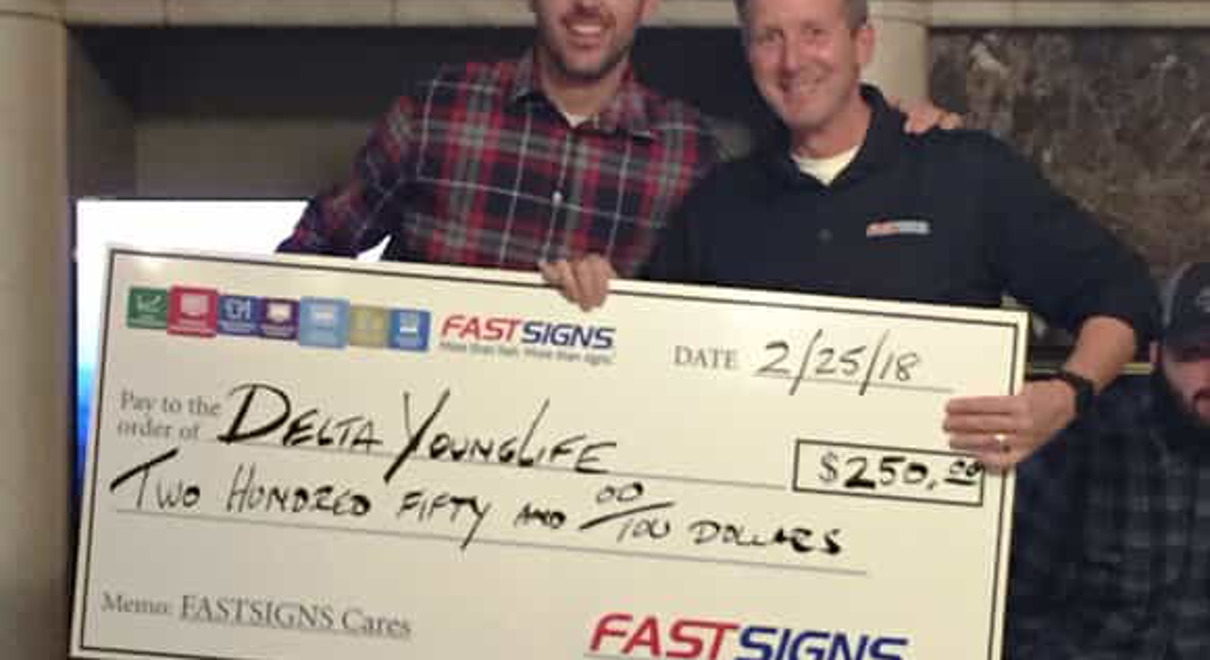 FASTSIGNS delivers a check to Delta Young Life