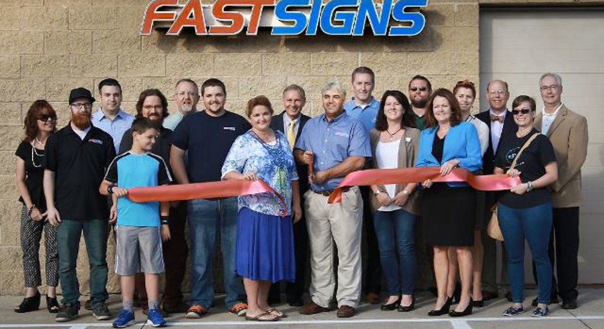 Ribbon cutting with franchise staff