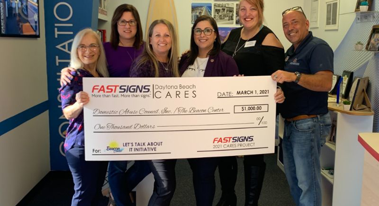 Franchise team with donation check