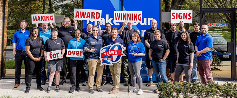 team image of fastsigns columbia, md holding signs saying thanks for an award-winning year