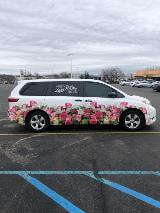 White car with flower car wrap