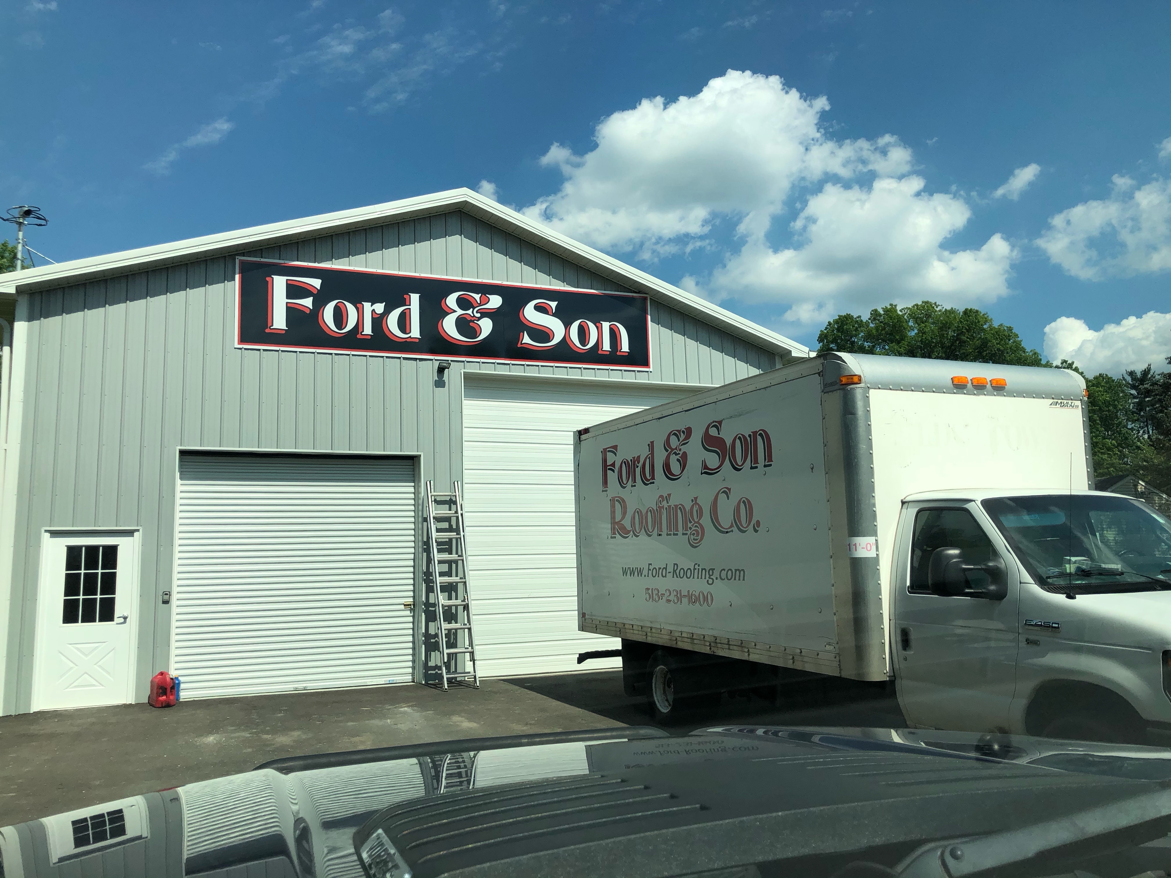Ford & Son signage on the  white warehouse with truck in front