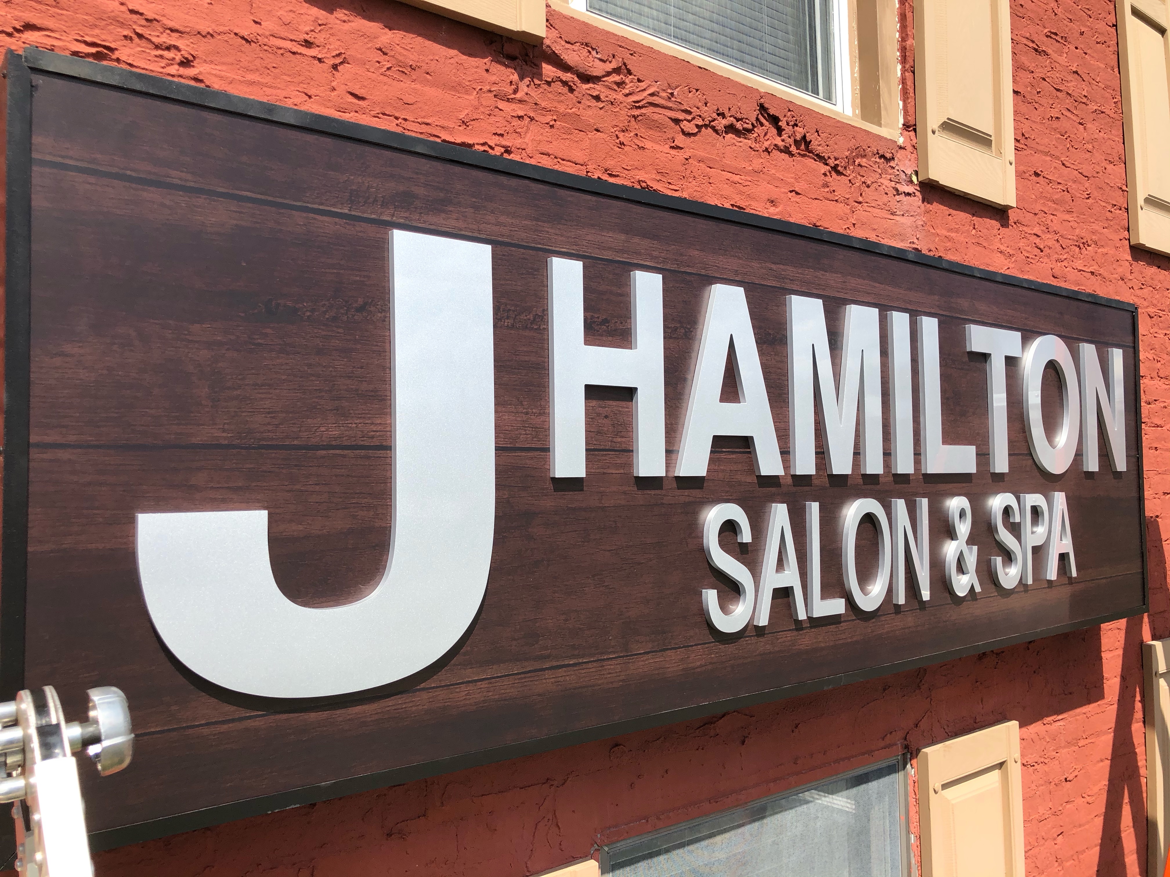 J Hamilton Salon & Spa signage on the orange building