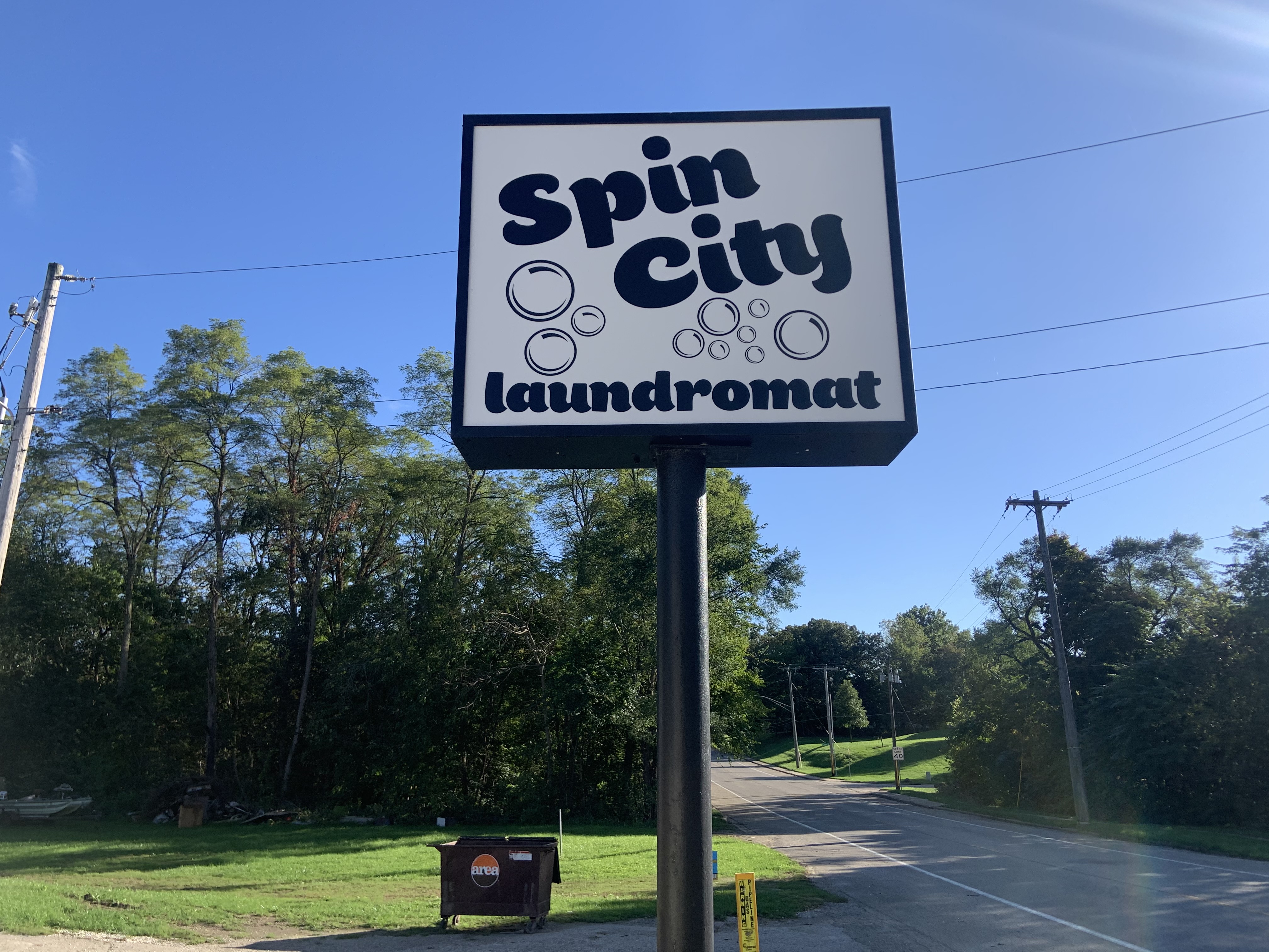 Exterior business sign for Spin City Laundromat