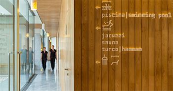 The walls of a hotel uses native material to show directional information