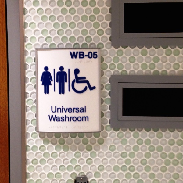 An ADA sign indicating a universal washroom
