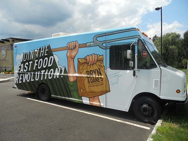 A food truck by Bryn & Dane's is covered in a vehicle wrap