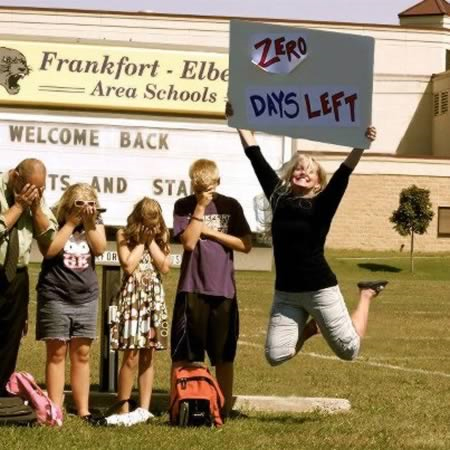 A mom cheers with a sign saying "Zero days left"