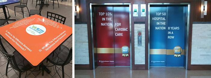 Sponsorship logos are placed on a table and on elevator doors