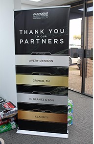 A vertical banner thanks sponsors