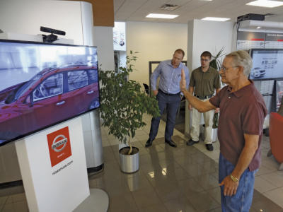 A Nissan dealership has a digital sign that allows customers to virtually interact with vehicles