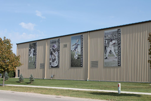 Banners of athletes are hung along the side of a building
