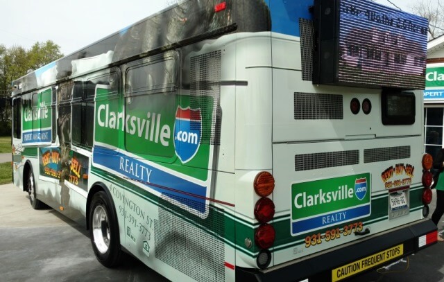 Bus wrapped with decal and digital sign on back of bus