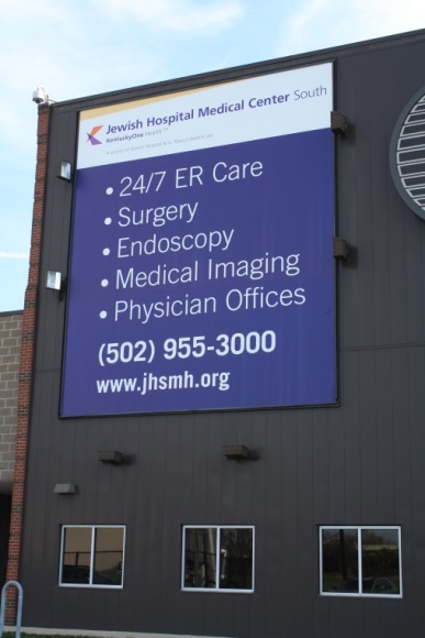 A hospital uses a giant sign on the side of their building to show services they offer