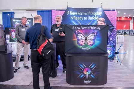 A man gives an explanation of a product at a trade show