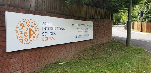 A school has a sign outside welcoming students and guests