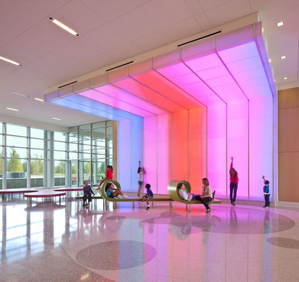 A children's hospital has colorful lights and interesting shaped benches