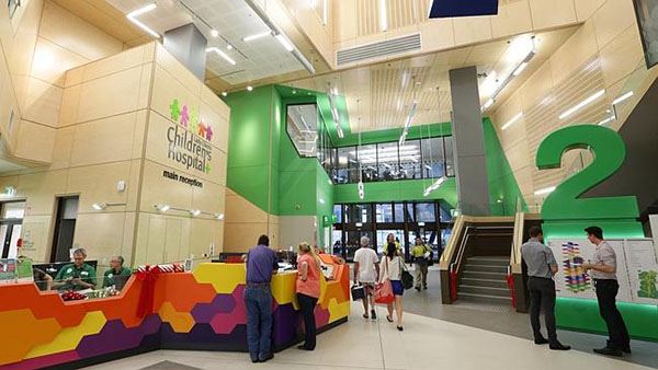 A children's hospital has colorful interior decor and bright prominent wayfinding signs