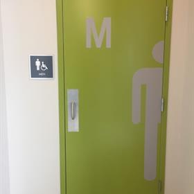 ADA Compliant signage indicates a men's restroom