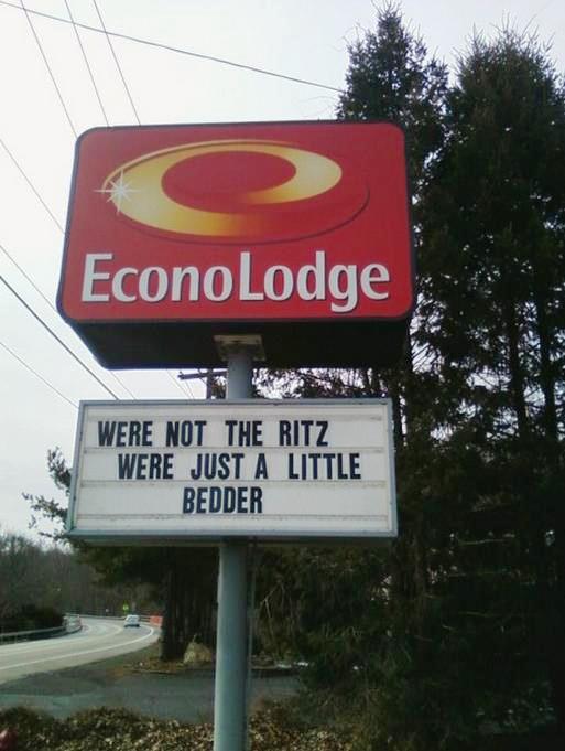An EconoLodge has a sign that says "We're Not the Ritz We're Just a Little Bedder"