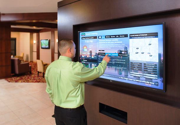 A man interacts with a digital sign to find out information