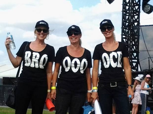 Three women wear custom hats and t shirts for Bruce Springsteen