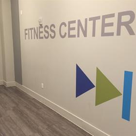 Wall graphics indicate a fitness center