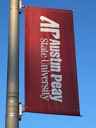 Austin Peay State University hangs flags around the campus with their logo on it