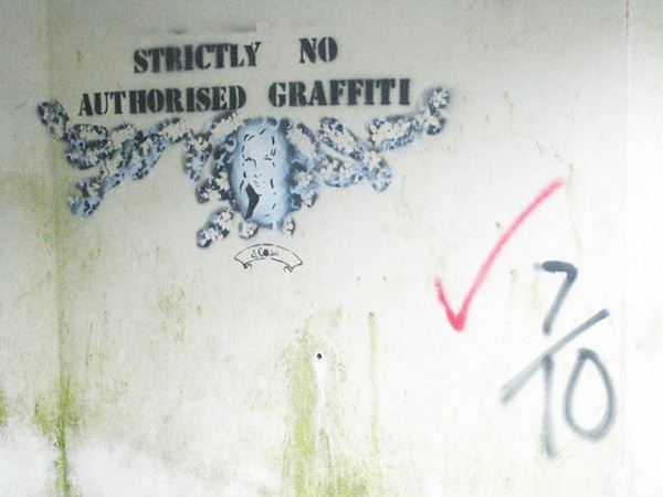 A wall has a sign saying "Stricty No Authorised Graffiti"