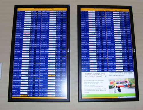 An electronic board at an airport provides information on upcoming flights