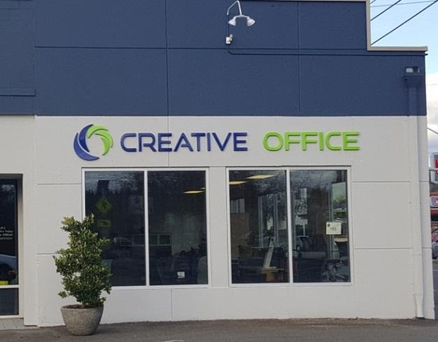 A building has the words "Creative Office" in dimensional lettering outside the building