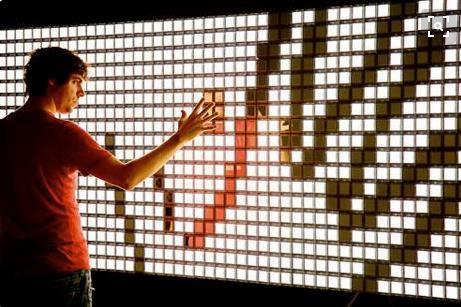 An interactive wall has an LED screen that mimics the user's actions